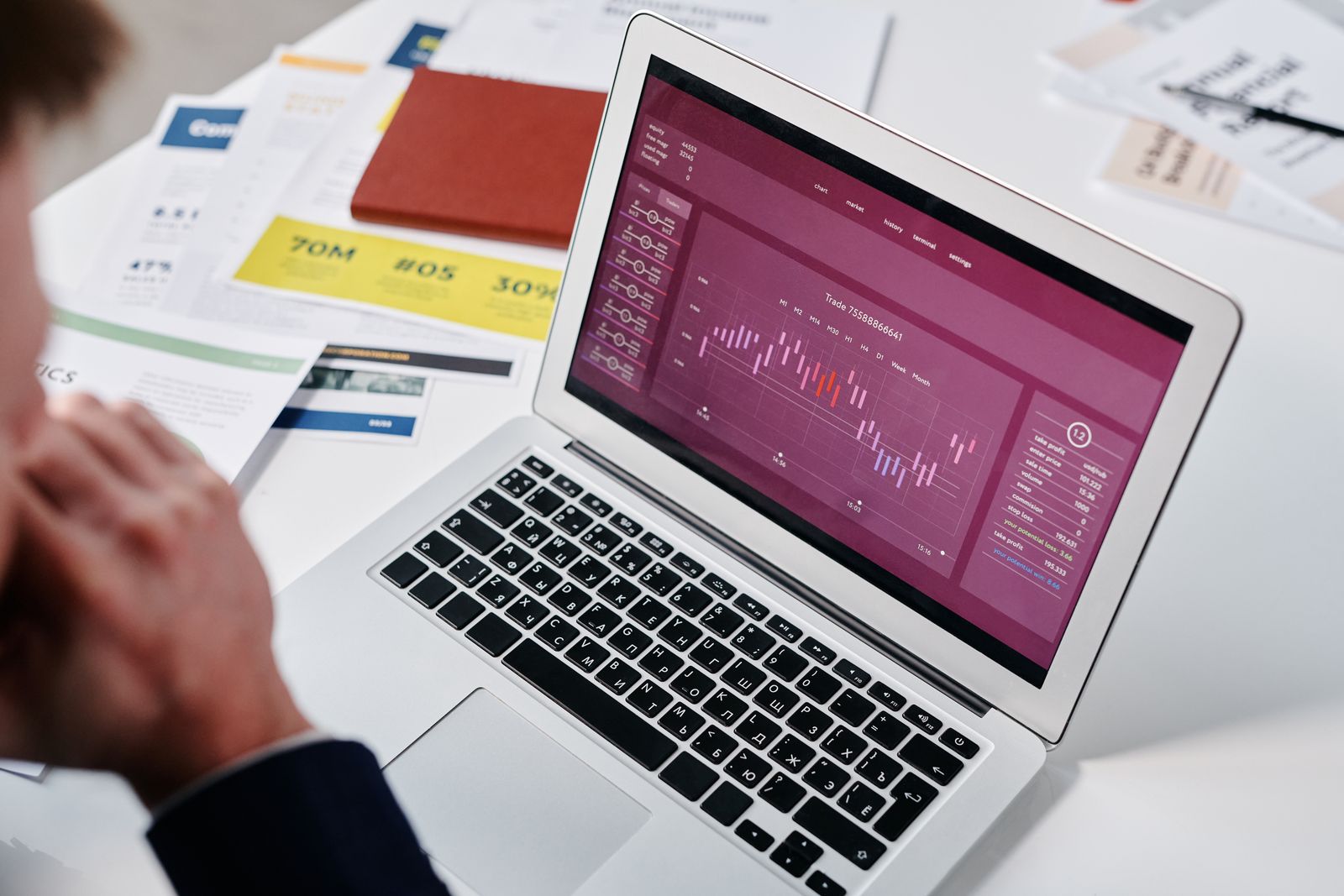 Small business owner reviewing a purple analytics chart on a laptop screen while auditing website performance data