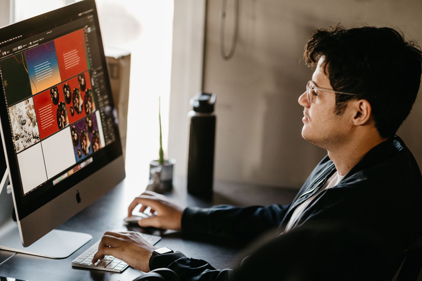 web designer working on a website mockup and layout on a computer screen in a modern office