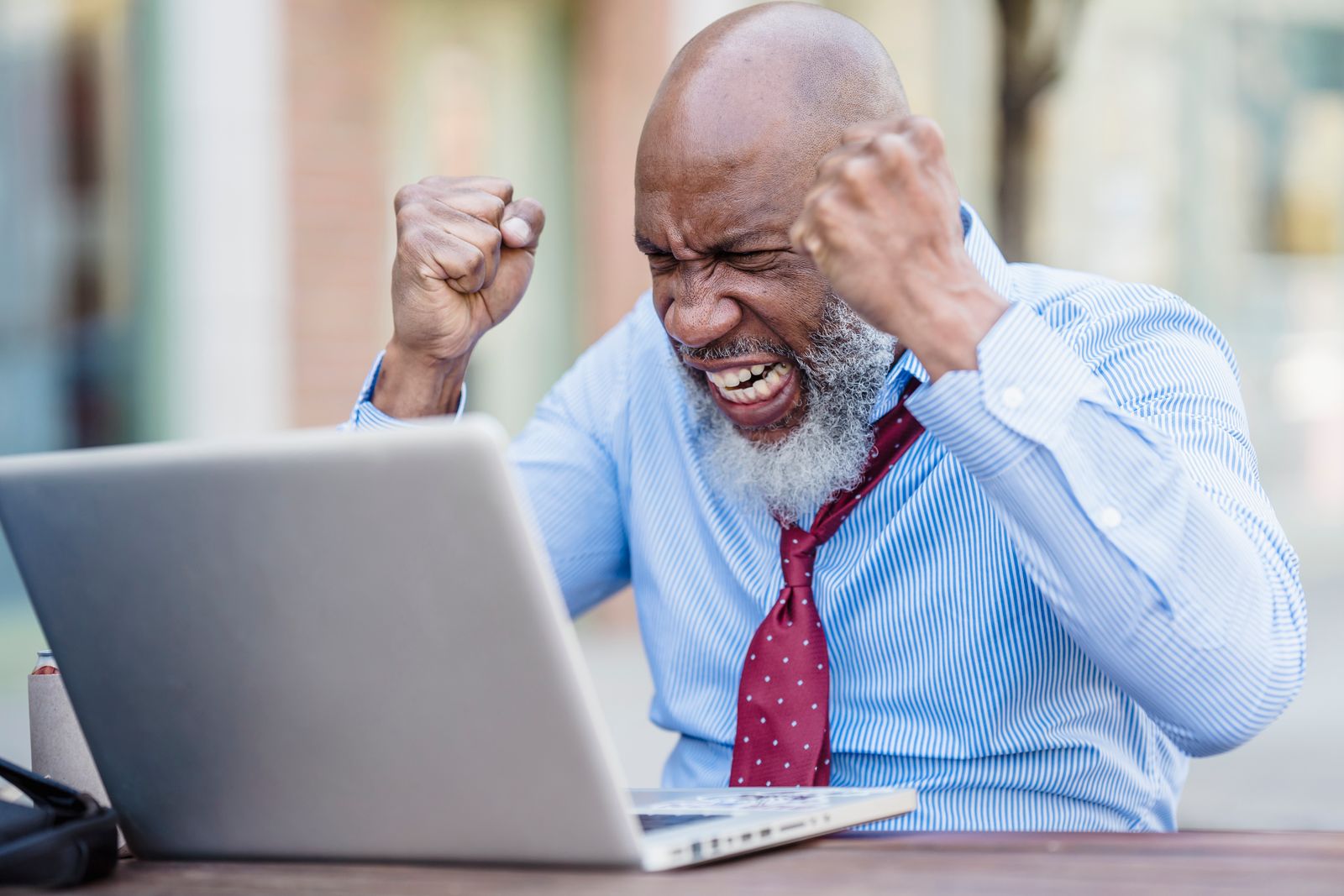 Frustrated business owner staring at a laptop screen, visibly annoyed while waiting for a slow-loading small business website