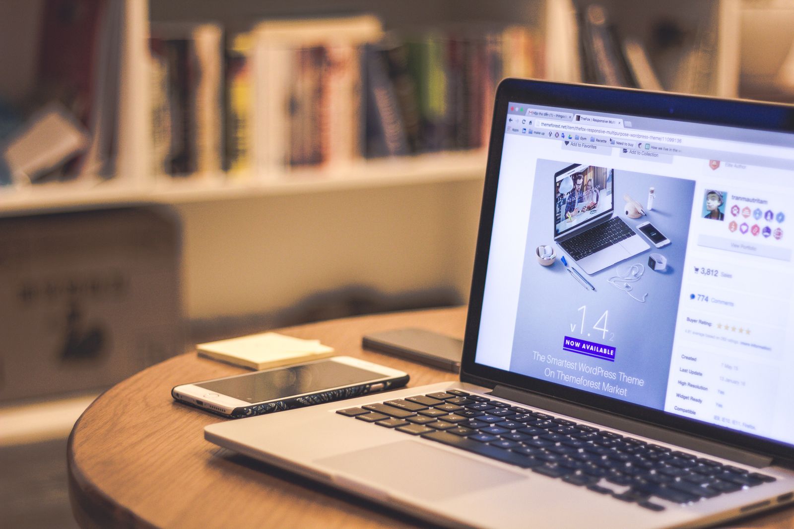 laptop displaying a website next to a smartphone on a wooden desk, illustrating mobile and desktop responsive website design for Ontario small businesses