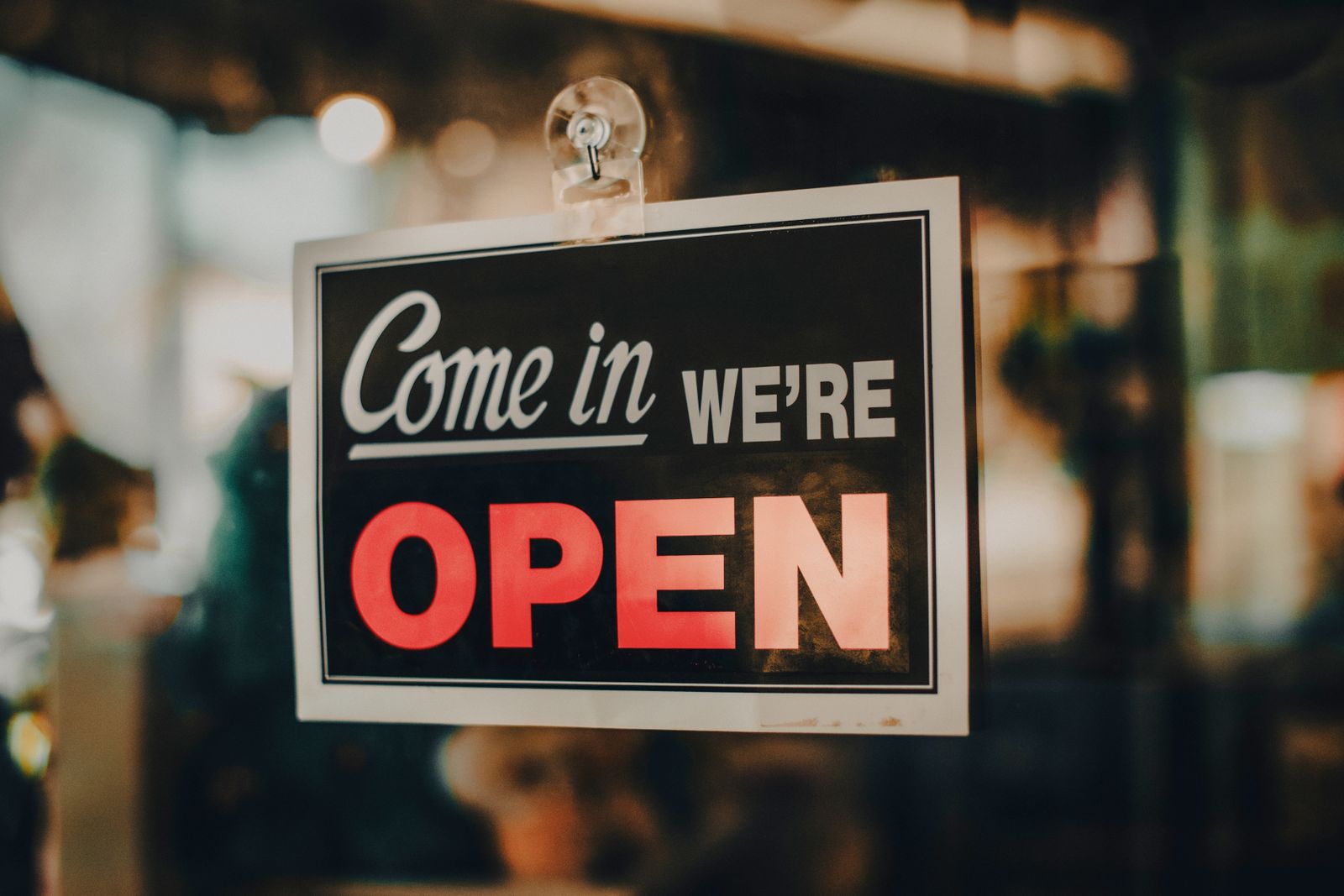 small shop storefront with an illuminated Open sign welcoming customers, representative of the independent local businesses that rely on local SEO in Ontario towns
